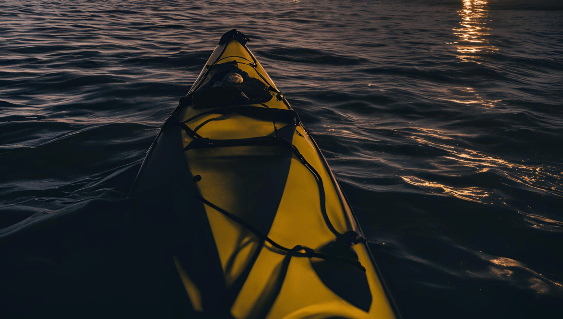 Glow kayaks lit up on the water at night in St. Thomas
